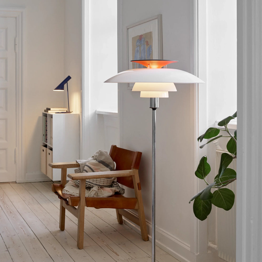 PH 80 Floor Lamp with white opal acrylic shades and a high lustre chrome plated stem in a living room