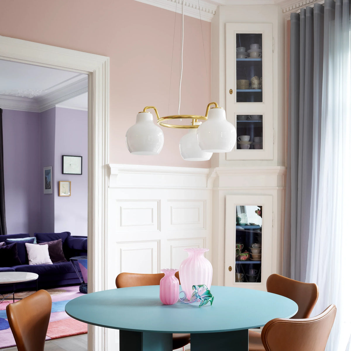 VL Ring Crown pendant with opal glass shades on a brass ring over a round teal dining table