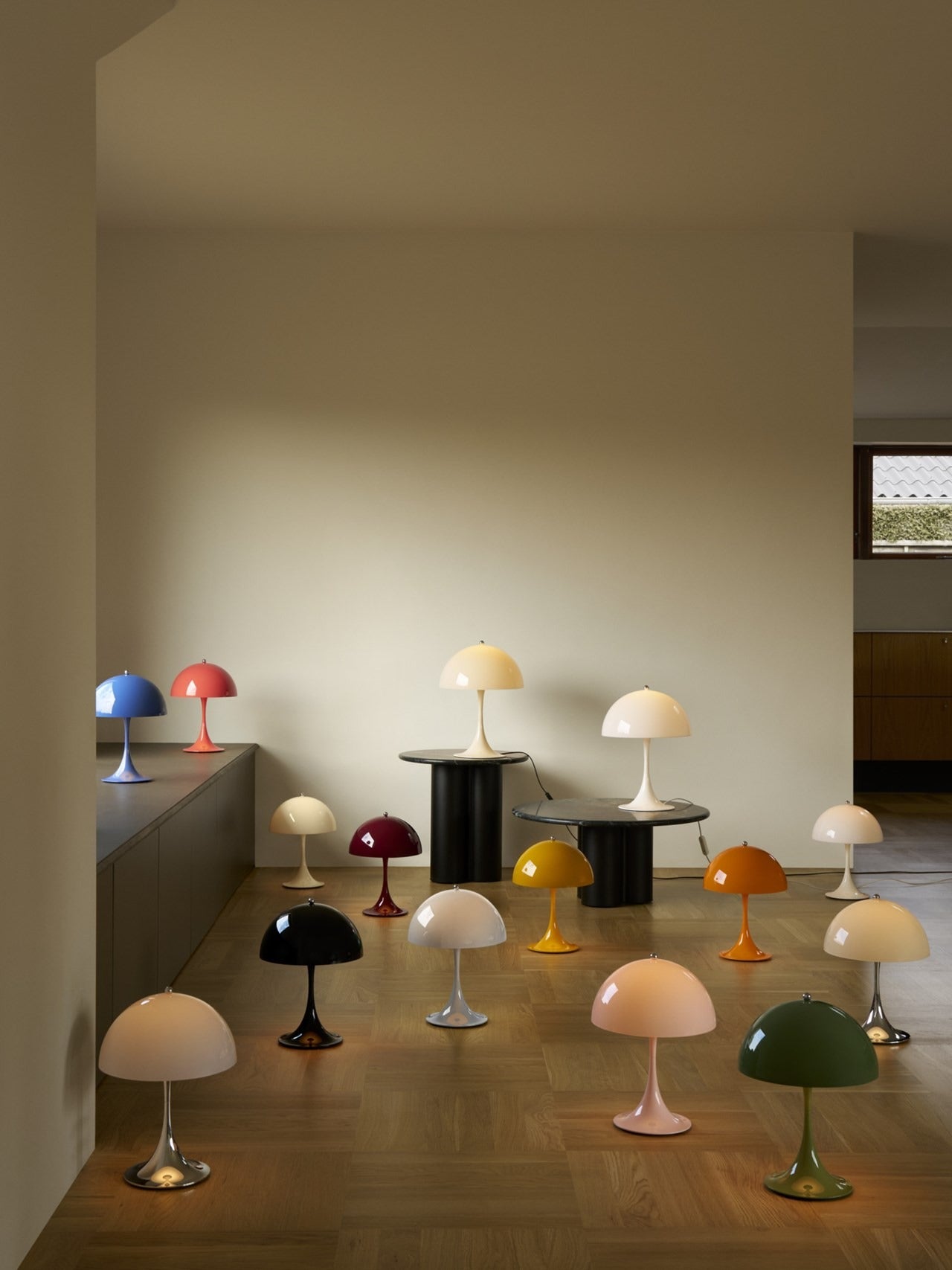 Panthella 250 Portable Lamp V3 lit on a low table in a family living room